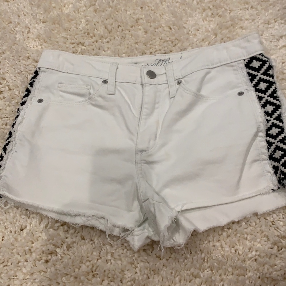 white jean shorts with black pattern on sides